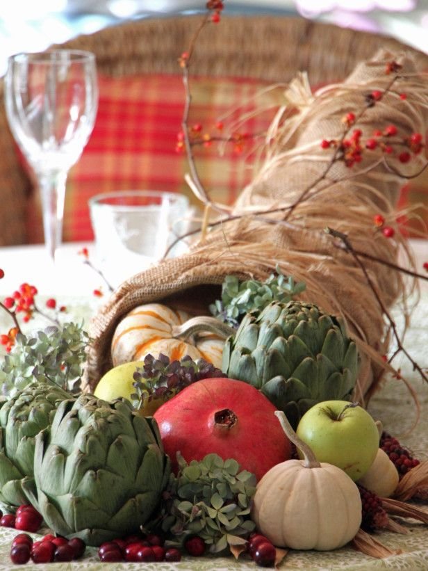 Farmhouse kitchen island, burlap cornucopia, artichokes, pomegranates, apples, natural daylight.