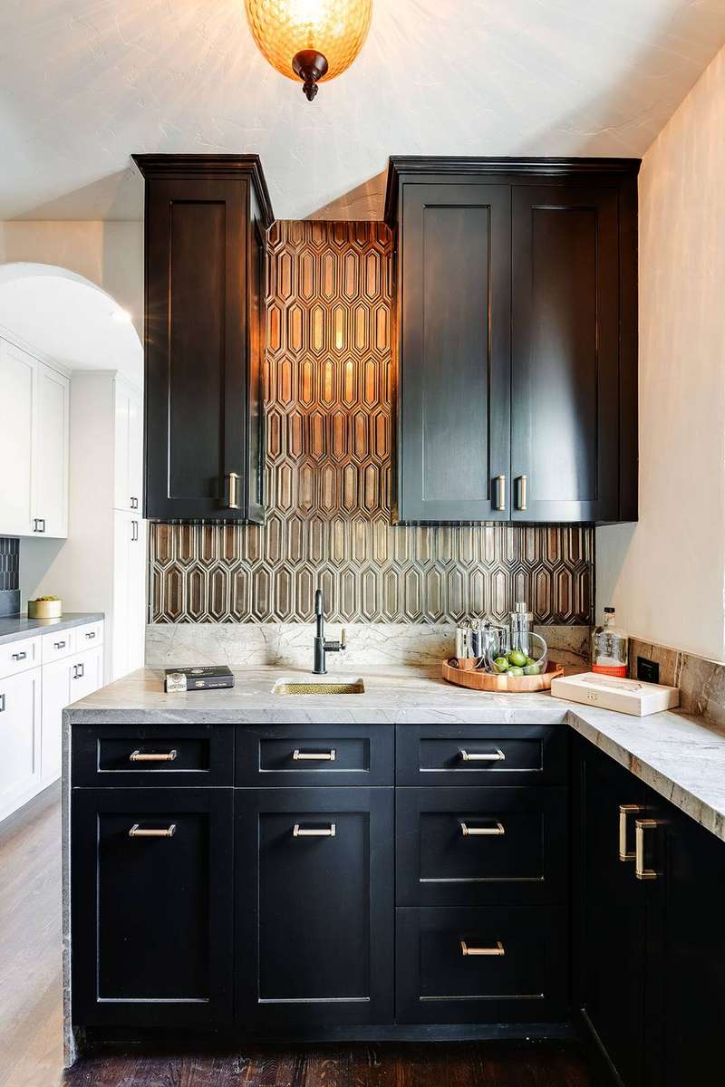 Modern butler’s pantry with matte black cabinets, polished brass hardware, and white quartz countertops.