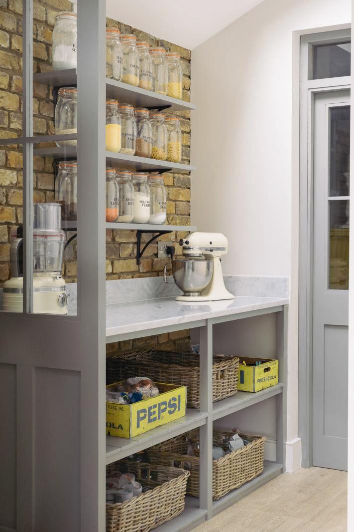 A minimalist butler’s pantry with open gray wooden shelves and clean, simple lines.