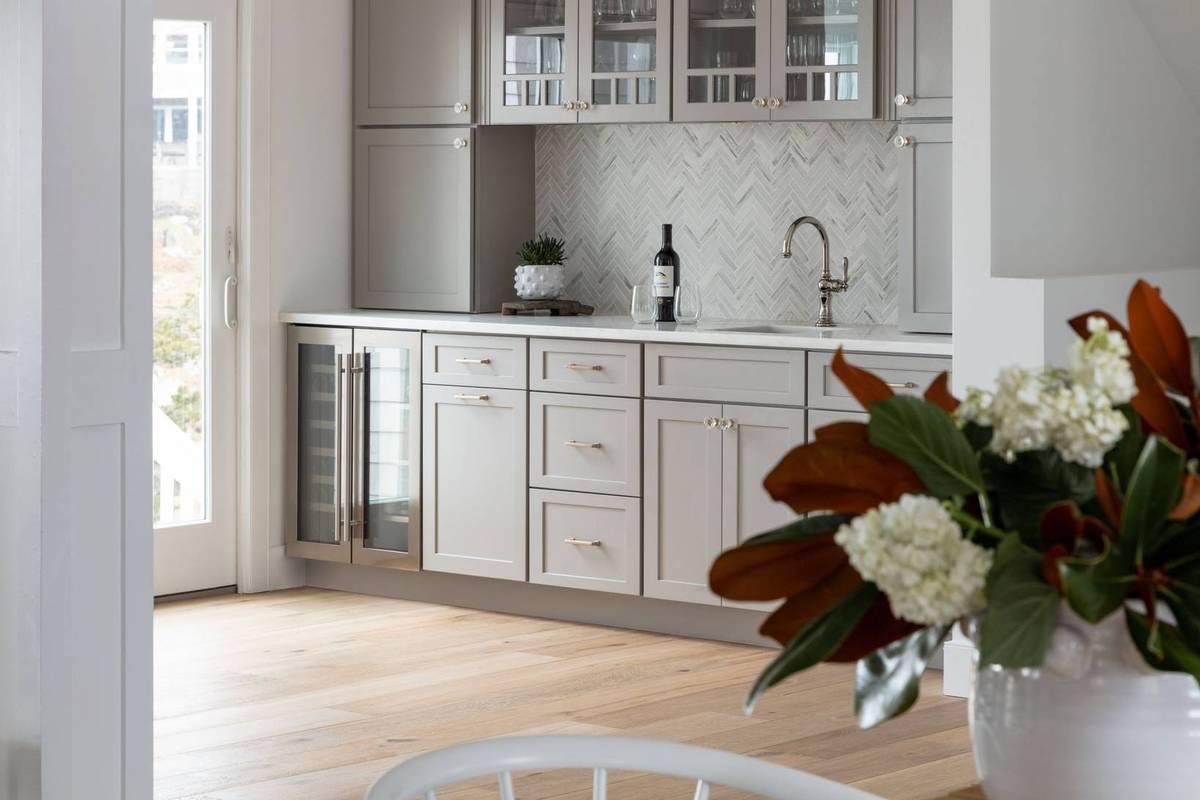 A gray-themed butler’s pantry with an integrated wine fridge and modern cabinetry.