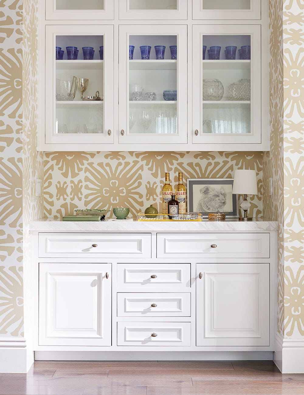 Modern white butler's pantry elevated with elegant white and gold metallic geometric pattern wallpaper.