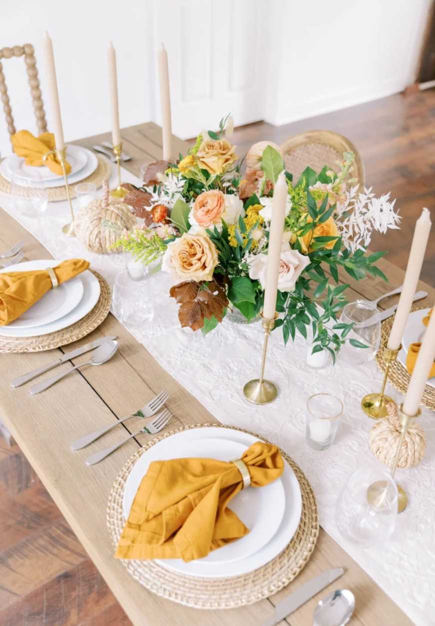Formal dining room, buttery yellow napkins, pastel floral arrangement, crystal glassware, soft white lighting