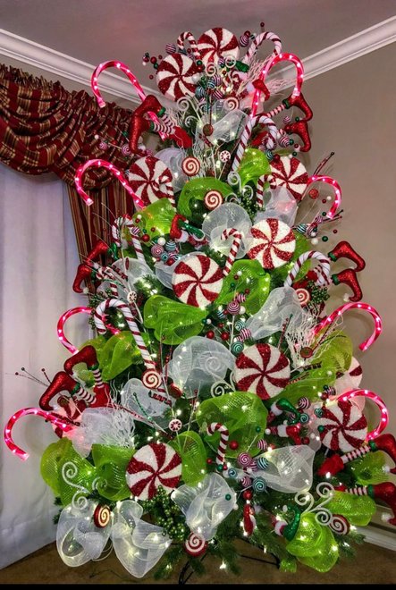 Tree decorated with red and white candy cane patterns and red elf shoe ornaments