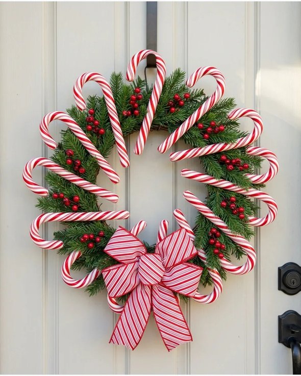 Candy cane wreath with striped pattern on white door