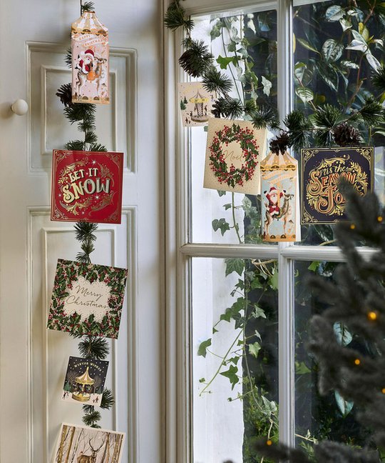 Bohemian study with natural wood bead garland strung across bookshelves holding paper greeting cards.