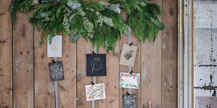 Traditional study featuring oversized tufted linen pinboard holding cards with vintage pearl pins.