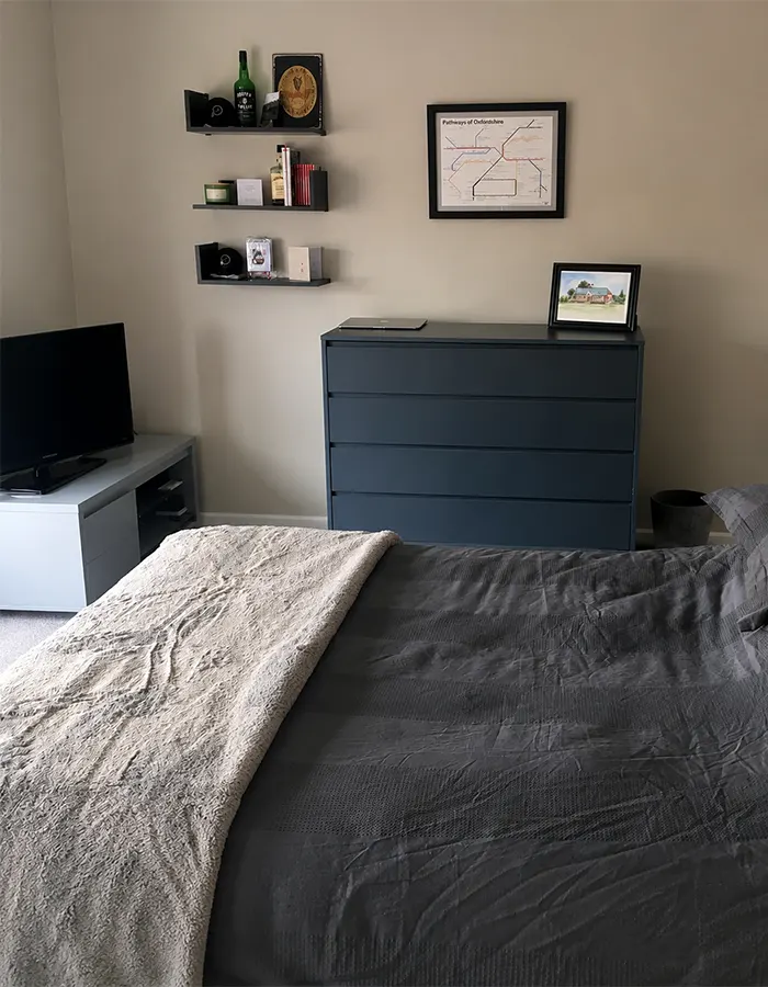 Charcoal bedding set against soft neutral walls, creating a balanced masculine retreat.