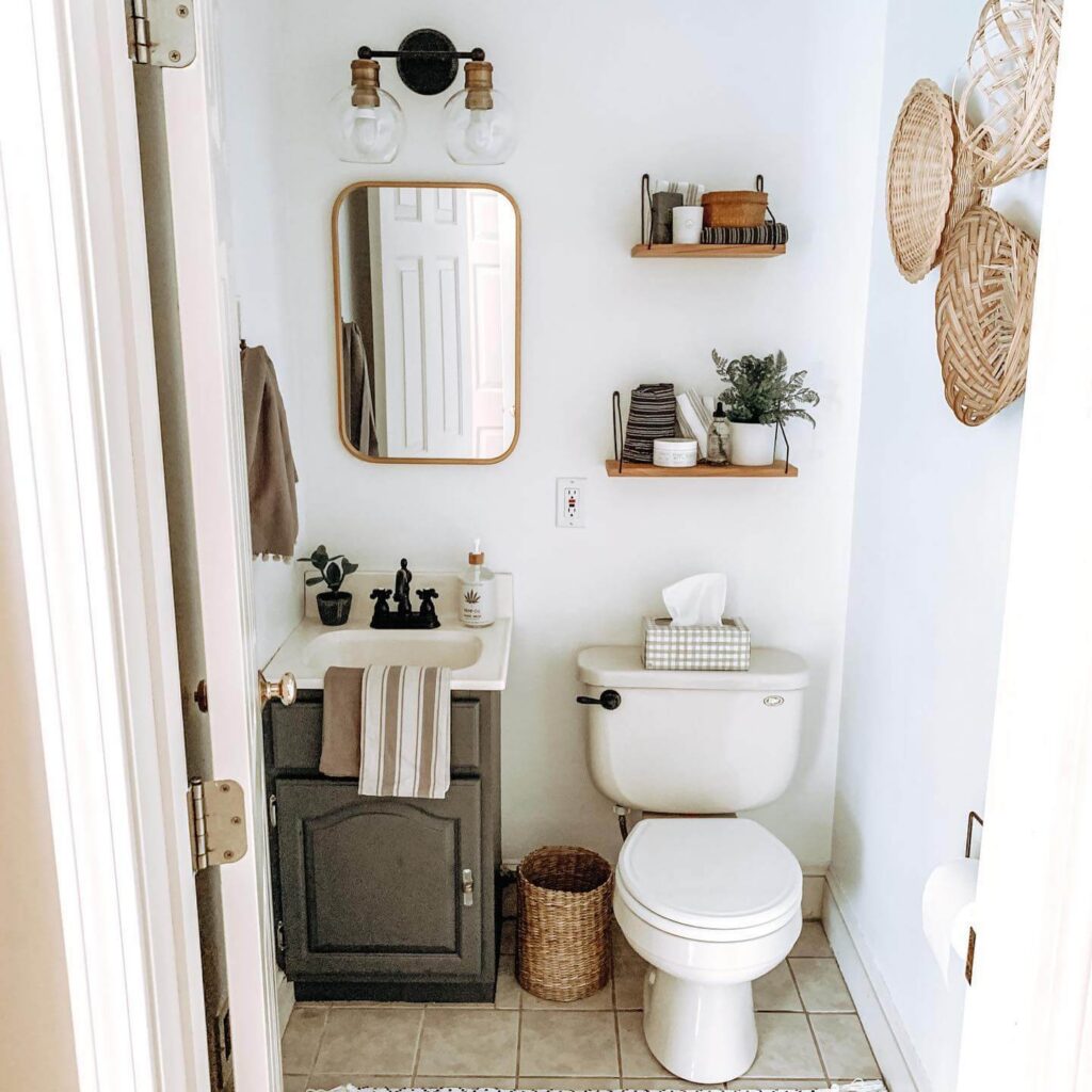 Half bathroom with charcoal vanity, woven storage baskets, matte black fixtures.