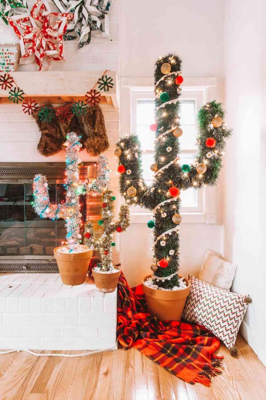 Modern living room corner featuring a cactus shaped tree, gold accents, warm fairy lighting.