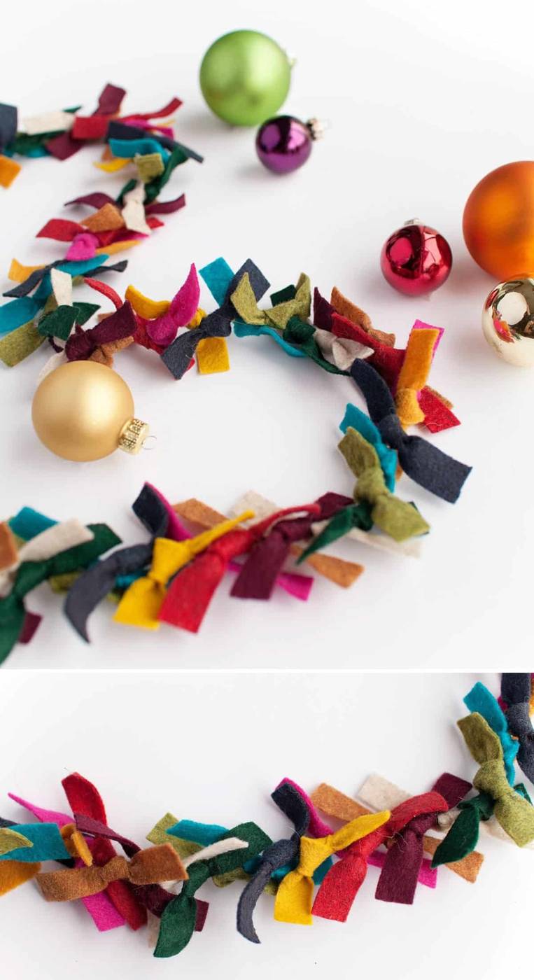 Staircase railing adorned with colorful velvet ribbons, greenery, gold accents, warm lighting.