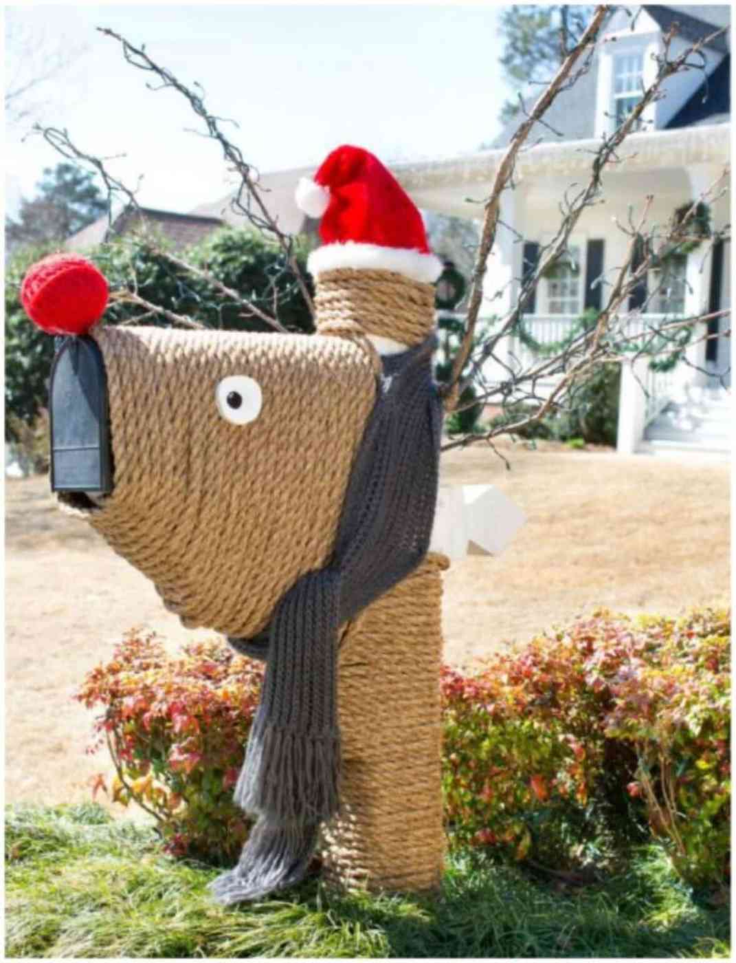 A charming outdoor display featuring glowing reindeer figures nestled in a snowy garden setting.