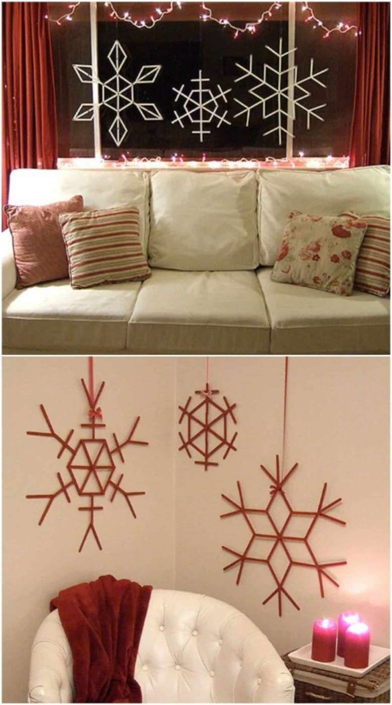 Elegant white snowflake decals applied to a large window overlooking a snowy landscape.