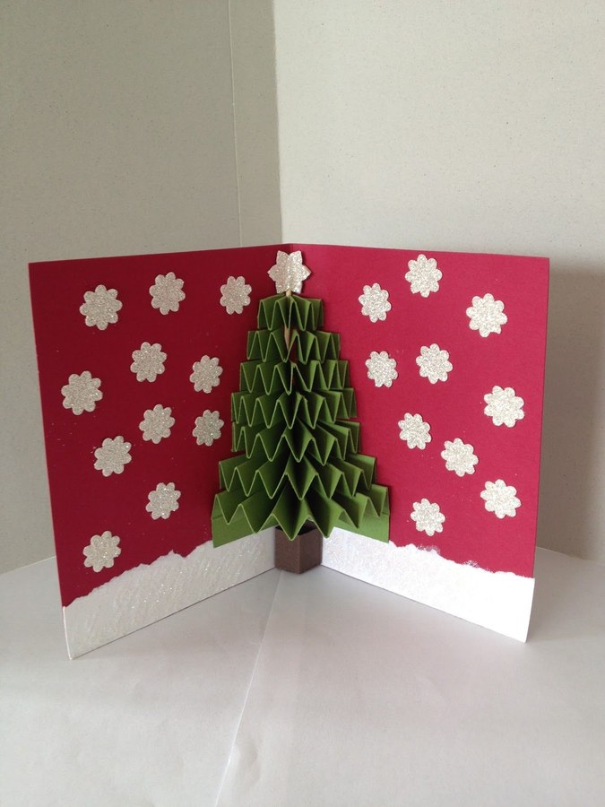 A reclaimed wooden ladder wrapped in garland displaying holiday cards with wooden clothespins.
