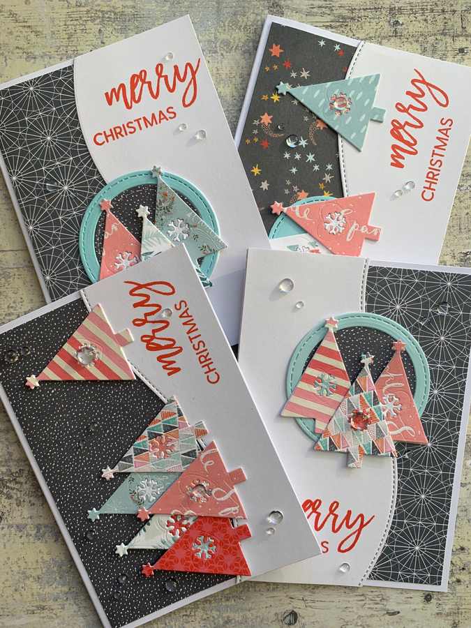 Vertical crimson velvet ribbons hung on a wall displaying gold-embossed Christmas cards.