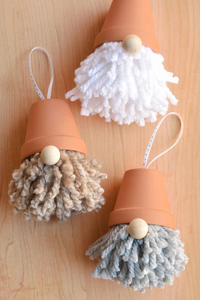 Clear glass baubles filled with pressed flora tied with rose velvet ribbon soft tree light background