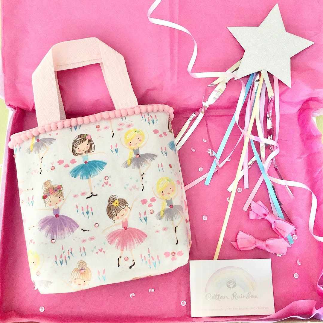 Nursery room with white crib, felt star garland, soft pastel colors, warm fairy lighting.