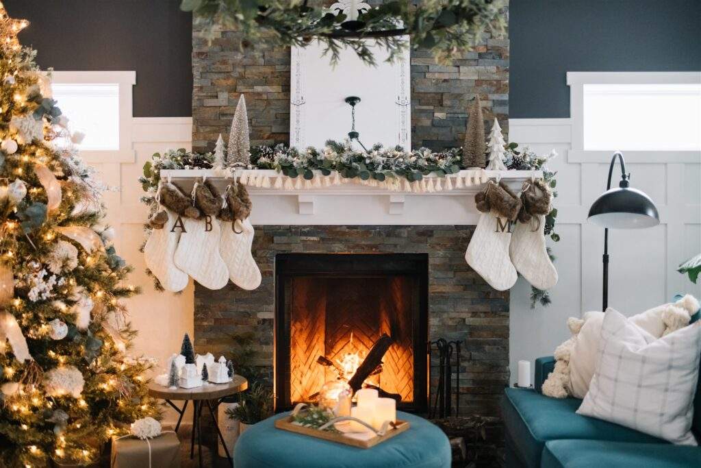 Reading chair with wool throw, paper star lamp, oak side table, minimalist holiday decor, soft lighting.