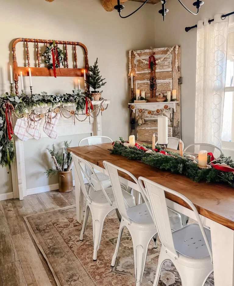 Farmhouse dining room with white metal chairs and a mantle with stockings.