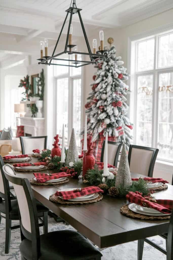 Rustic dining table with red plaid napkins and a black iron chandelier.