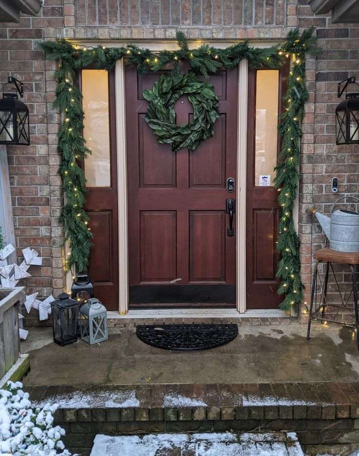 Luxurious christmas front door decorating ideas with long, cascading velvet ribbons on the door.