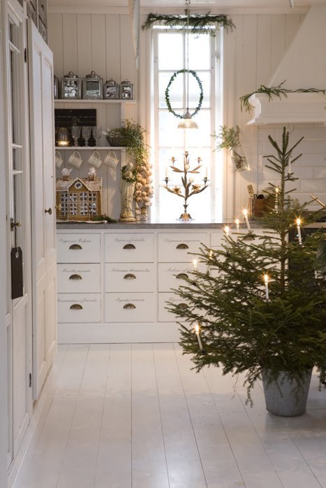 Kitchen with charcoal cabinets, LED string lights framing doors, soft glow, modern holiday style