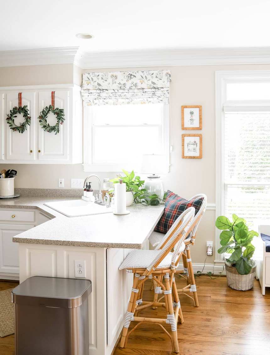 Kitchen with dark oak cabinets, copper tinsel trim, warm incandescent lighting, glamorous holiday sparkle