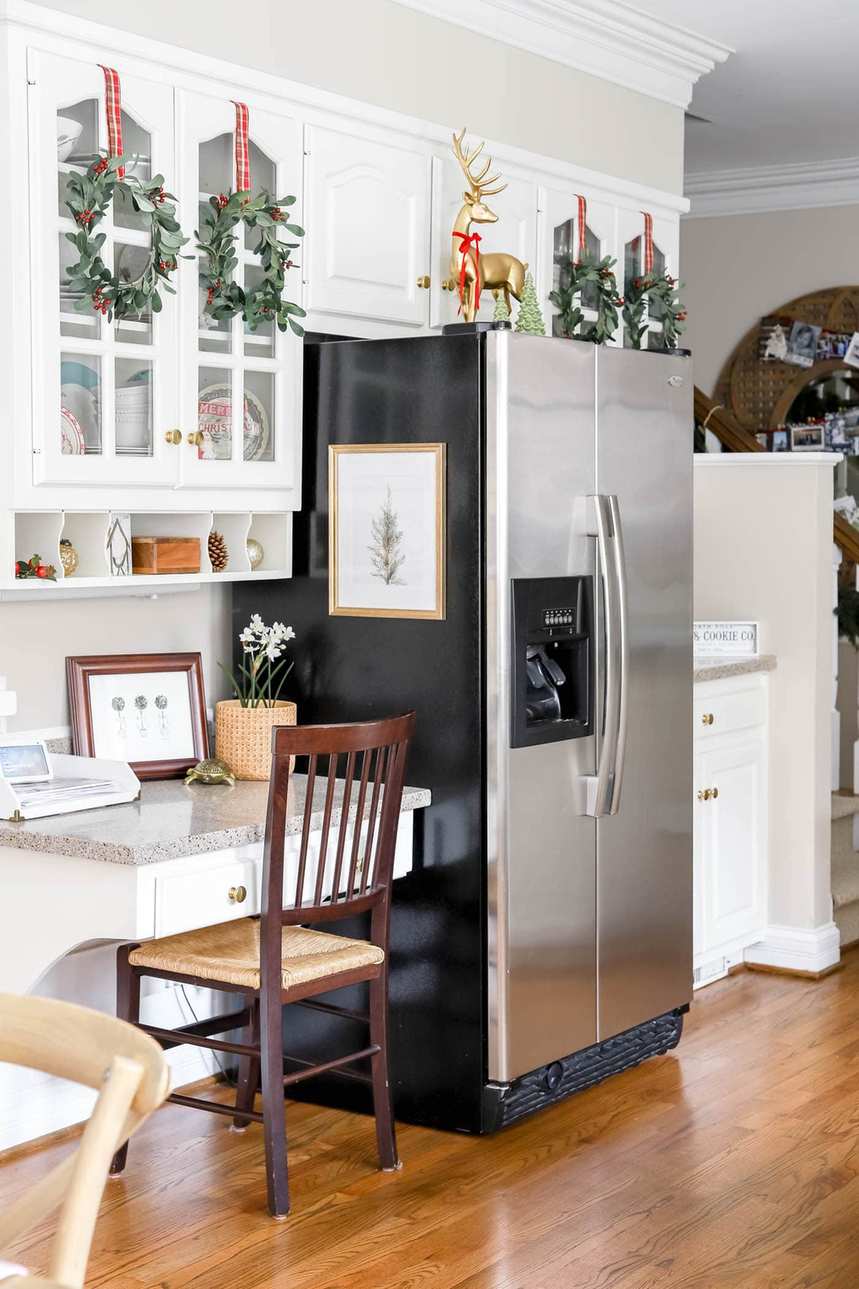 Kitchen with white cabinets, sage linen drawer liners, natural wood handles, cool daylight, fresh holiday feel