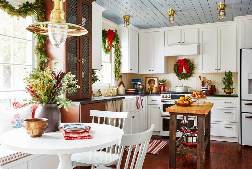 Kitchen with matte black cabinets, fine glitter spray, soft warm lighting, dramatic holiday contrast