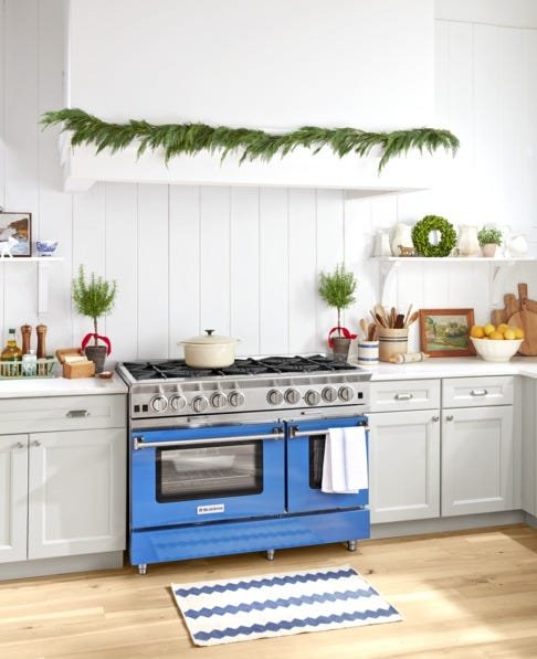Kitchen with navy cabinets, silver icicle LED strips, cool white lighting, wintery holiday ambience