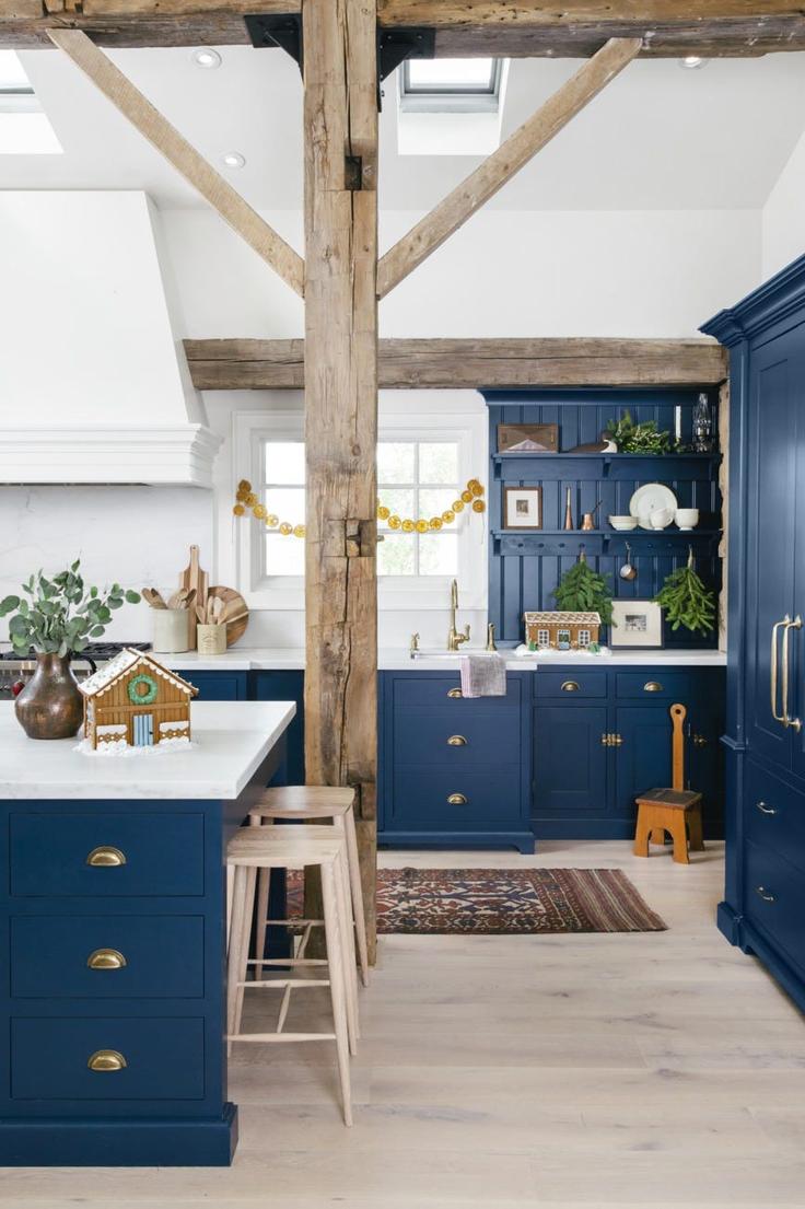 Kitchen with matte white cabinets, copper foil edging, warm lighting, luxe holiday detailing