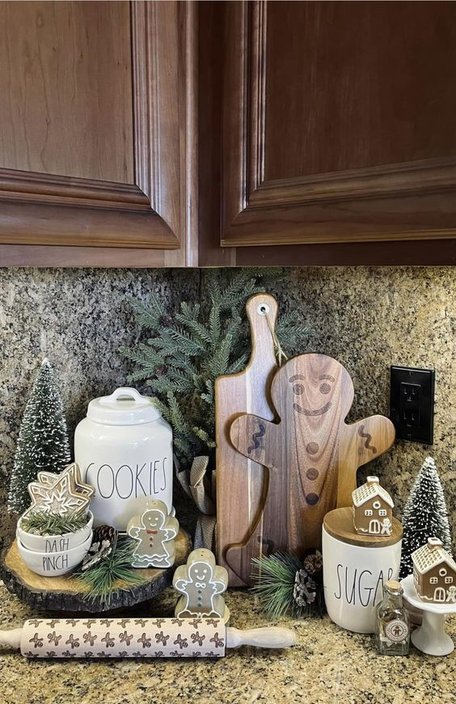 Red cast iron skillets and pots displayed on open kitchen shelves with holiday accents.