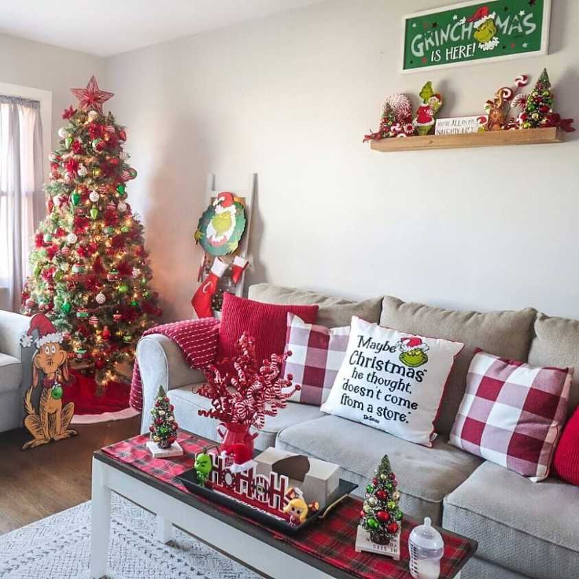 Whimsical grinchmas theme with grinch pillows and red plaid decor in a living room.