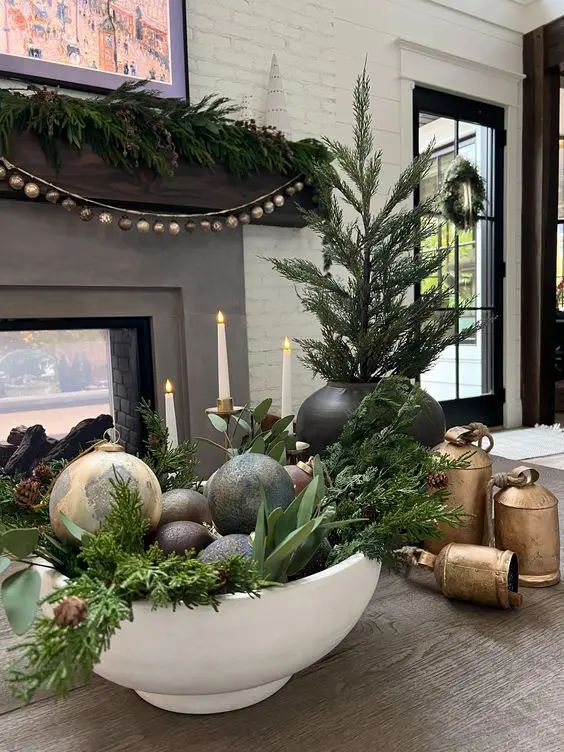 Cozy entryway console displaying glass apothecary jars filled with color-coordinated glass ornaments under warm lamp light.