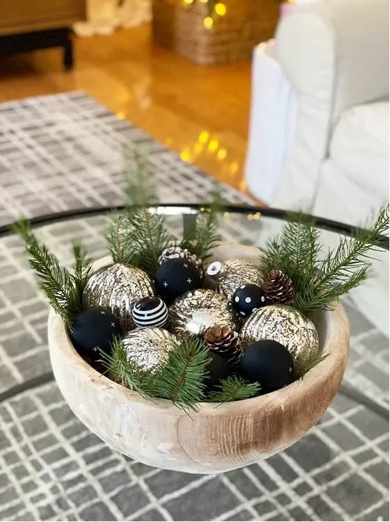 Farmhouse kitchen corner with wooden ladder, hanging ornaments on jute string, evergreen sprigs.