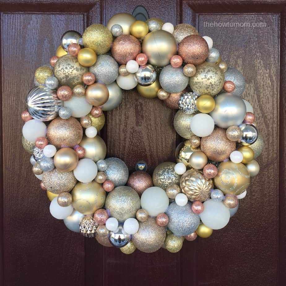 Mudroom featuring woodland berry ornament wreath, reclaimed wood bench, warm sconces, and woven storage baskets.