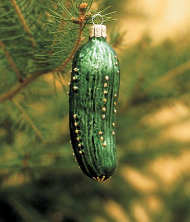 A colorful vintage style Christmas display featuring retro ornaments and a pickle ornament.