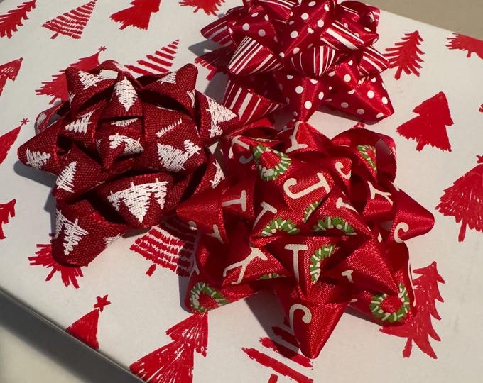 Kraft paper holiday gifts tied with frayed oatmeal linen ribbon and dried orange slices