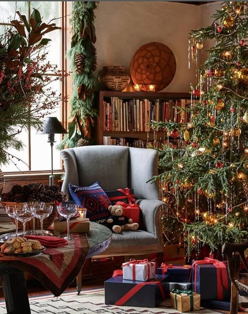 Classic Christmas tree beside a large window, gold glass ornaments, soft natural daylight, ivory rug.