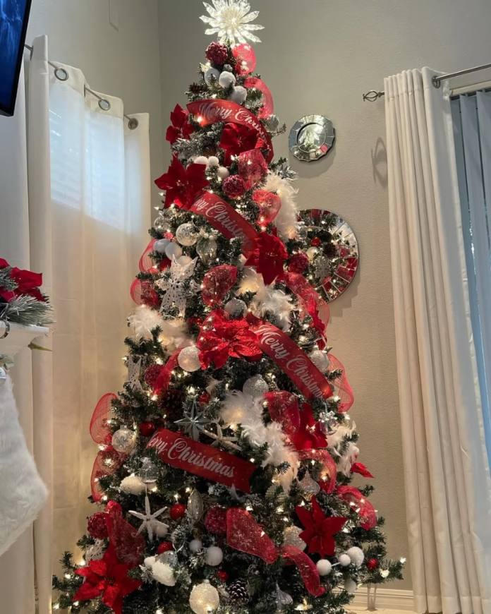 Spacious living room, massive Christmas tree, elegant furniture, floor‑to‑ceiling windows