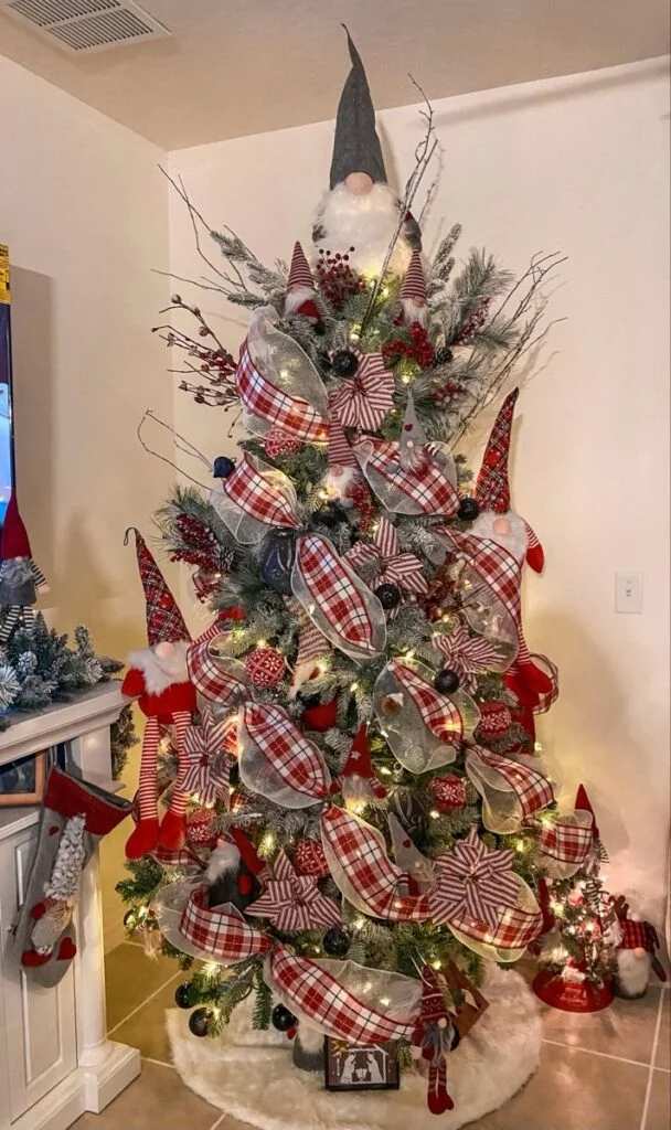 Playful family room, Christmas tree with oversized gnomes, plaid ribbon, bright lighting