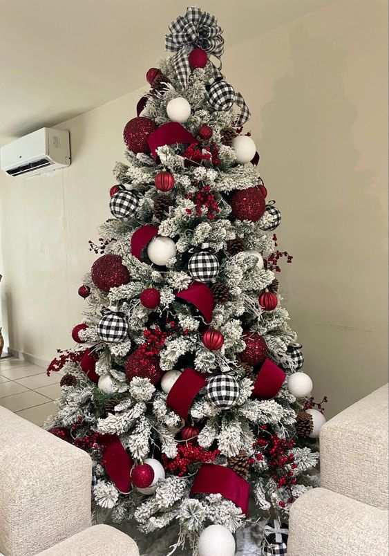 Living room, heavily flocked Christmas tree, black and white plaid ribbon, deep red ornaments, ambient lighting