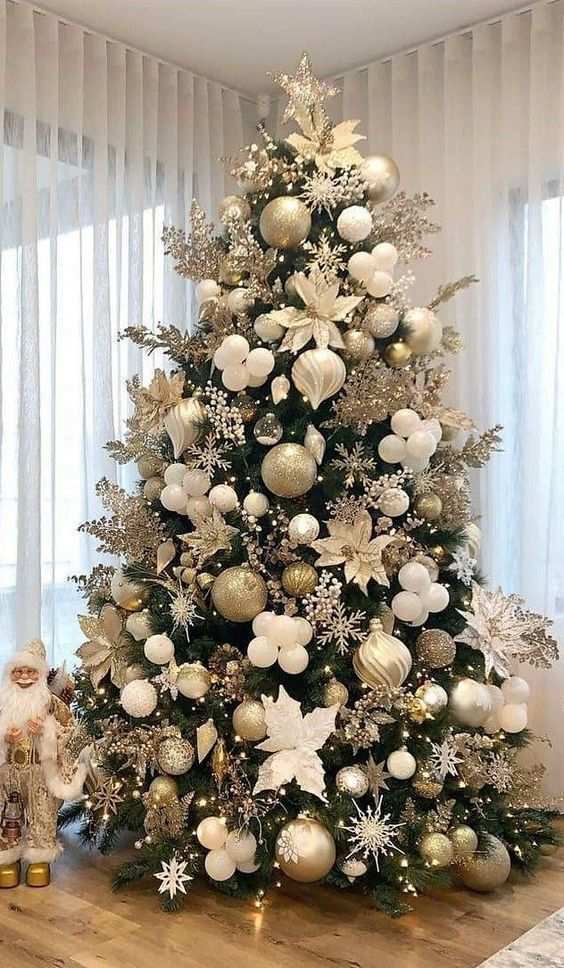 Expansive living room, large Christmas tree, gold and silver ornaments, star topper, contemporary sofa