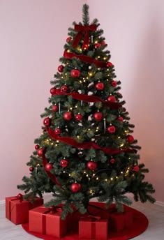Minimalist living area, small Christmas tree, red ribbon, red-wrapped presents, clean lines