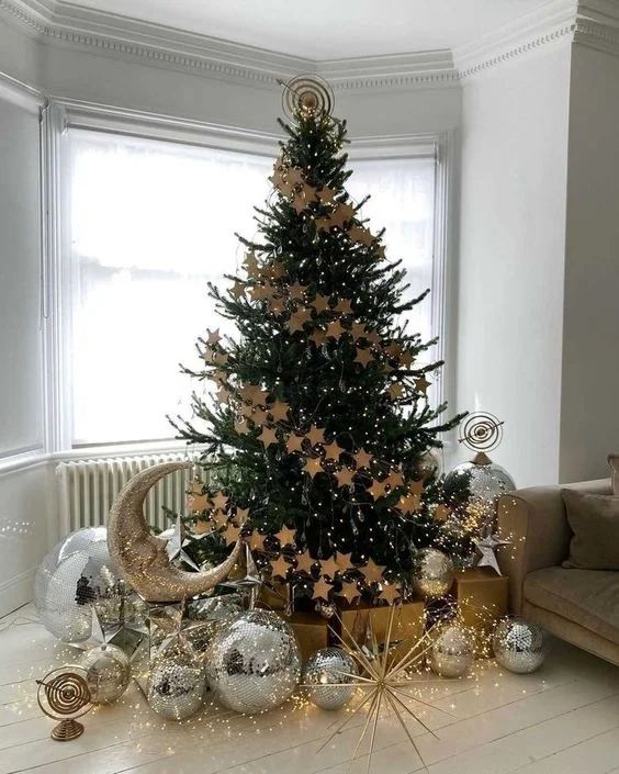 Modern loft, Christmas tree decorated with gold star cutouts, disco balls, vibrant lighting