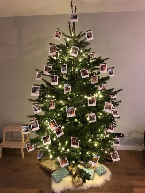 Contemporary living room, Christmas tree with Polaroid photos clipped to branches, modern décor