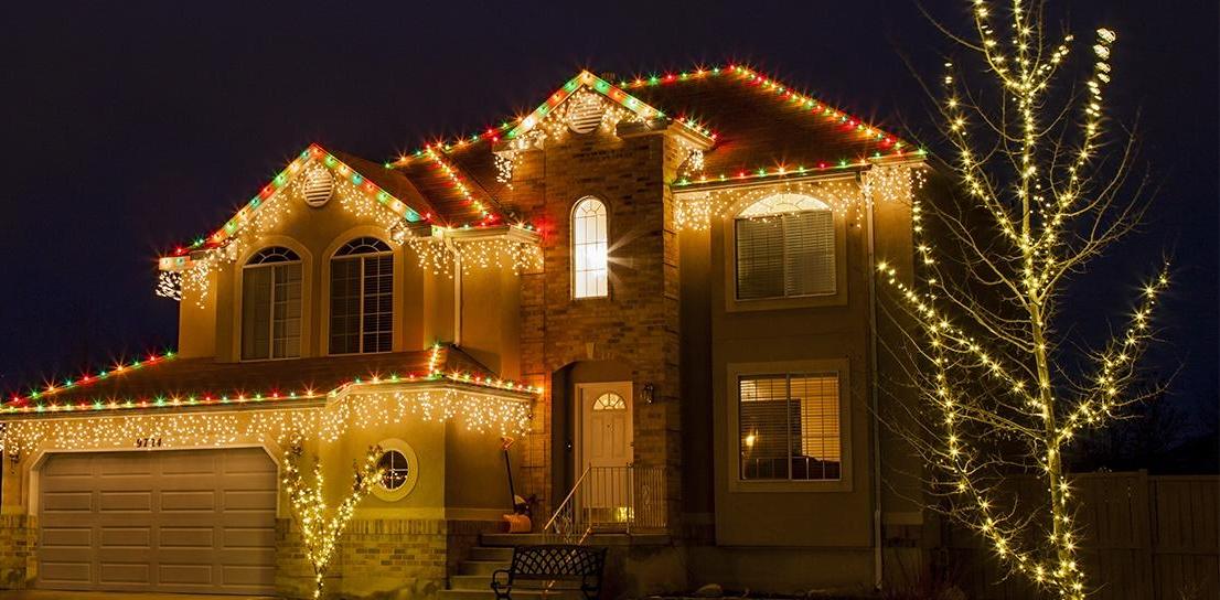Cascading icicle string lights on an interior porch mantel with natural evergreen garland