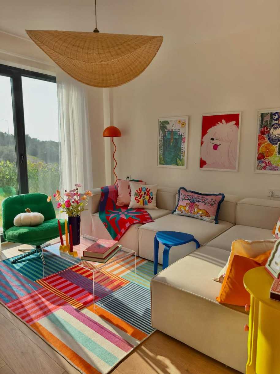 Modular sofa on a striped rug with colorful cushions.