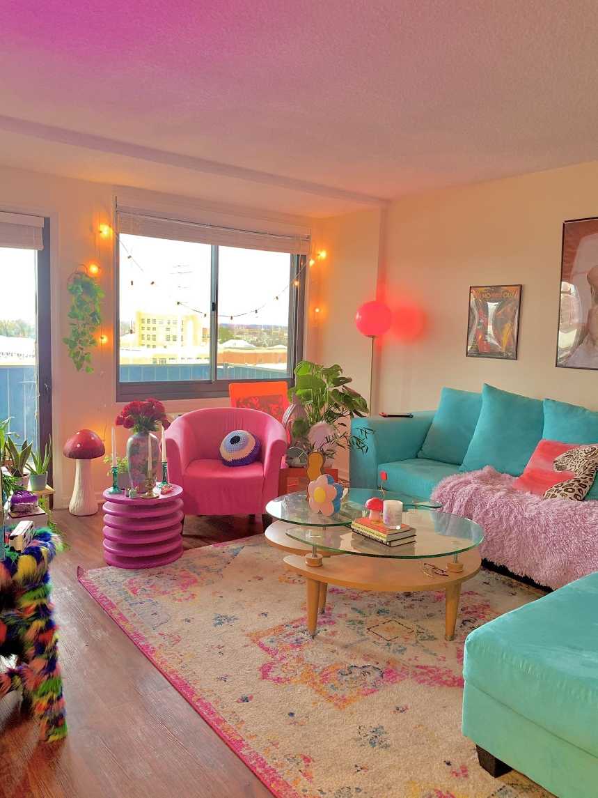 Living room with a turquoise sectional sofa and neutral decor.