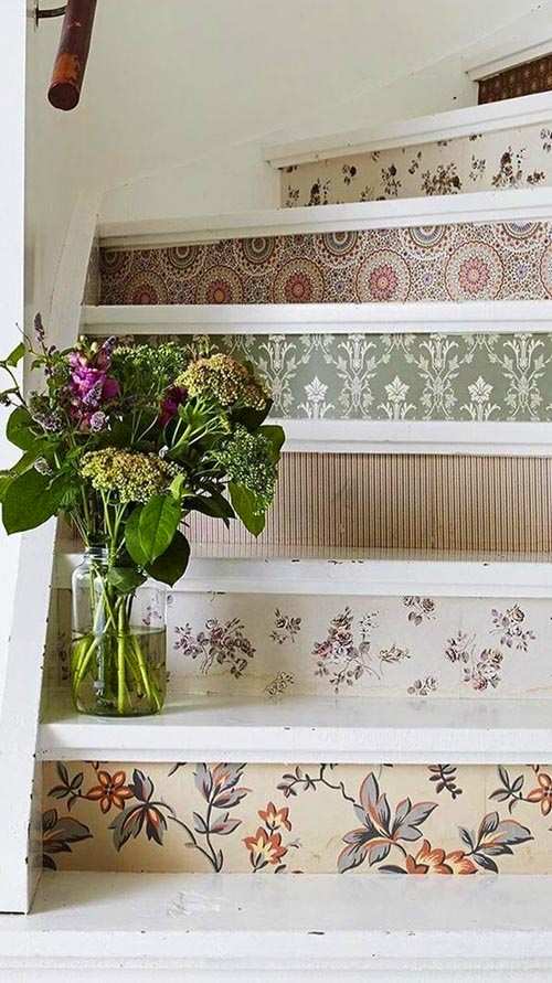Country staircase with floral wallpaper, wooden banister, and vintage decor, charming style