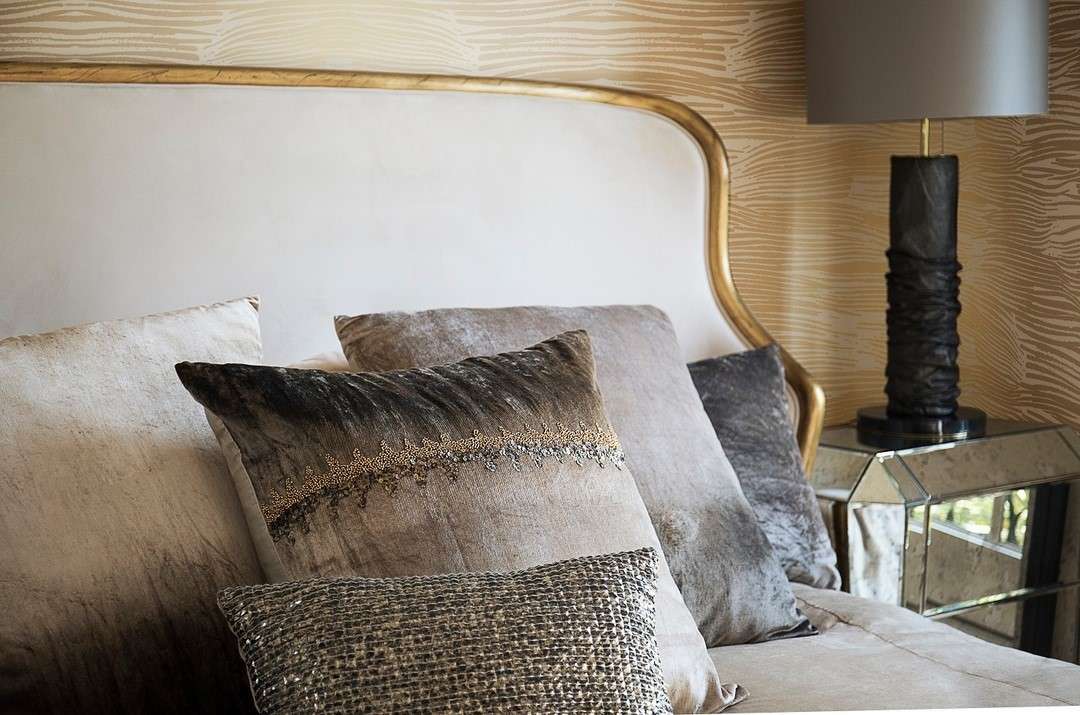 Couples bedroom featuring dark walnut bed mustard yellow cushions retro brass lamp warm ambient glow